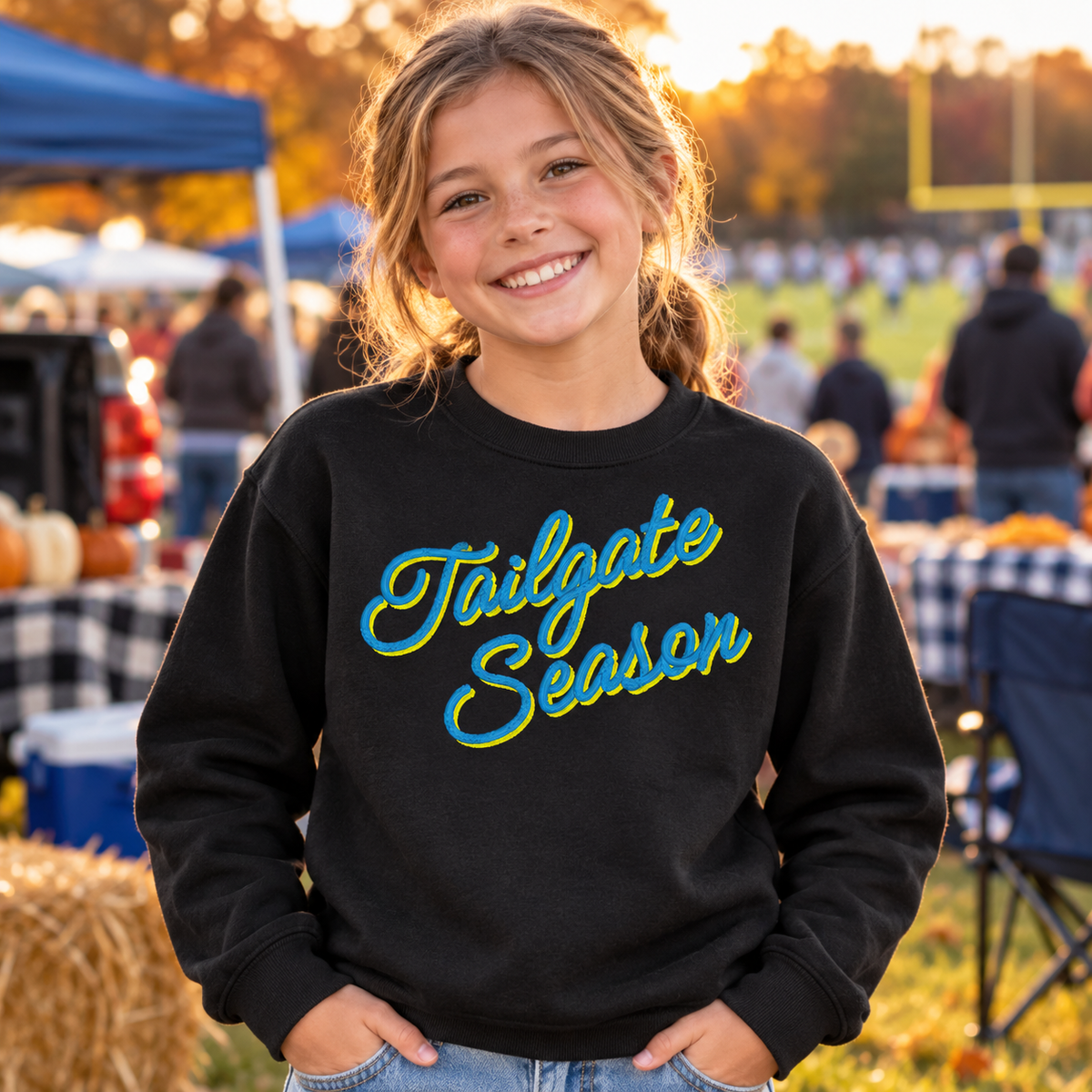 Youth black embroidered Tailgate Season sweatshirt with custom team color thread at a fall game day